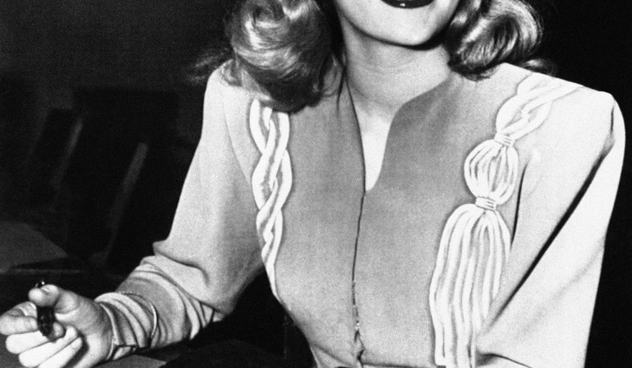 FILE - In this Dec. 26, 1945, file photo, actress Peggy Cummins, 20, smiles in Superior Court, in Los Angeles, after her contract with Twentieth Century-Fox Studio had been approved. Cummins, who gave an indelible performance as the lethal, beret-wearing robber in the noir classic "Gun Crazy," has died. Cummins, who retired from acting in the early 1960s, died Friday, Dec. 29, 2017, in London at age 92. (AP Photo/File)