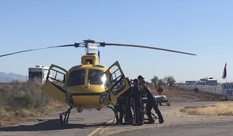 First responders load an injured passenger onto a helicopter for transportation to a hospital Friday, Dec. 29, 2017 at Rooster Cogburn Ostrich Ranch in Picacho, Ariz. Twelve people were injured when the tour truck they were riding in rolled over. (Maria Vasquez/Casa Grande Dispatch via The AP)