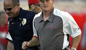 FILE - In this Sunday Nov. 4, 2007 file photo, Tampa Bay Buccaneers head coach Jon Gruden, right, leaves the field after an NFL football game against the Arizona Cardinals  in Tampa, Fla. Jon Gruden says he hopes he&#39;s a candidate to return for a second stint as coach of the Oakland Raiders and believes a final decision will be made next week.  Gruden made his most specific comments about the opening in Oakland created when the Raiders fired Jack Del Rio following a disappointing six-win season in an interview Tuesday, Jan. 2, 2018 with the Bay Area News Group. (AP Photo/Chris O&#39;Meara, File)