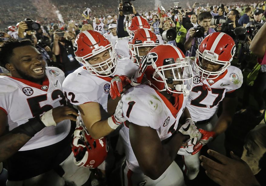Georgia tailback Sony Michel (1) celebrates with teammates after scoring the game-winning touchdown in the second overtime period to give Georgia a 54-48 win over Oklahoma in the Rose Bowl NCAA college football game, Monday, Jan. 1, 2018, in Pasadena, Calif (AP Photo/Doug Benc)