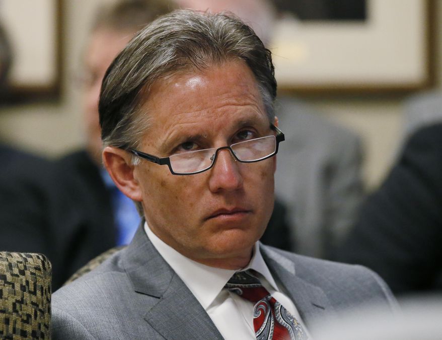 FILE - In this Feb. 21, 2017, file photo, Oklahoma Attorney General Mike Hunter sits at a Board of Equalization meeting in Oklahoma City. Hunter said a private organization of county sheriffs must make its meetings and certain records open to the public. (AP Photo/Sue Ogrocki, File)