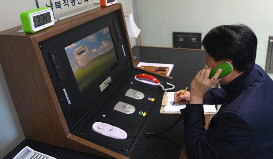 A South Korean government official communicated with a North Korean officer during a phone call on the dedicated communications hotline at the border village of Panmunjom on Wednesday — another sign of easing animosity between the rivals. (Associated Press)