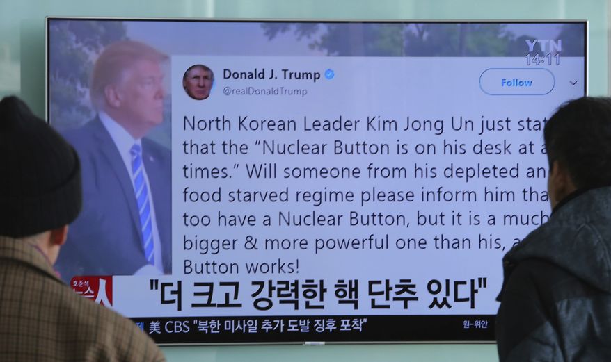 People watch a TV news program showing the Twitter post of U.S. President Donald Trump while reporting North Korea's nuclear issue, at Seoul Railway Station in Seoul, South Korea, Wednesday, Jan. 3, 2018. Trump boasted that he has a bigger and more powerful "nuclear button" than North Korean leader Kim Jong Un does but the president doesn't actually have a physical button. The letters on the screen read: "More powerful nuclear button." (AP Photo/Ahn Young-joon)