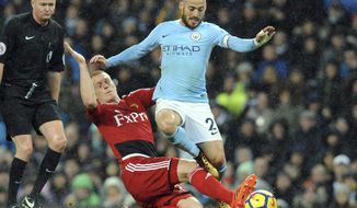 Manchester City&#x27;s David Silva, right, vies for the ball with Watford&#x27;s Ben Watson during the English Premier League soccer match between Manchester City and Watford at Etihad stadium, in Manchester, England, Tuesday, Jan. 2, 2018. (AP Photo/Rui Vieira)