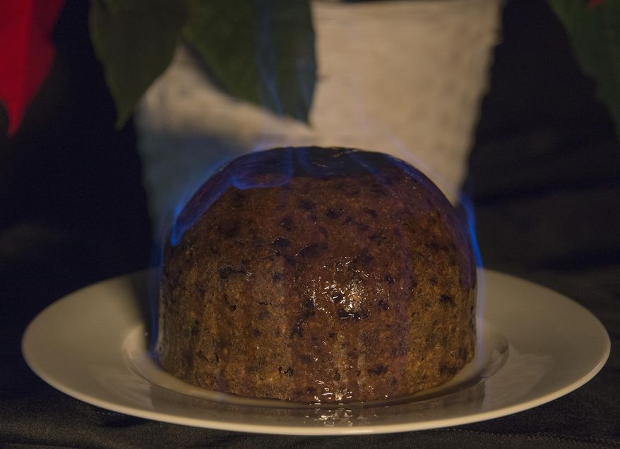 In this Tuesday, Dec. 19, 2017 photo, flamed Christmas pudding made from a recipe by Prof. H. I. Blits from a cookbook published in Pittsburgh in the 1890s is displayed in Pittsburg. (Lake Fong/Pittsburgh Post-Gazette via AP)