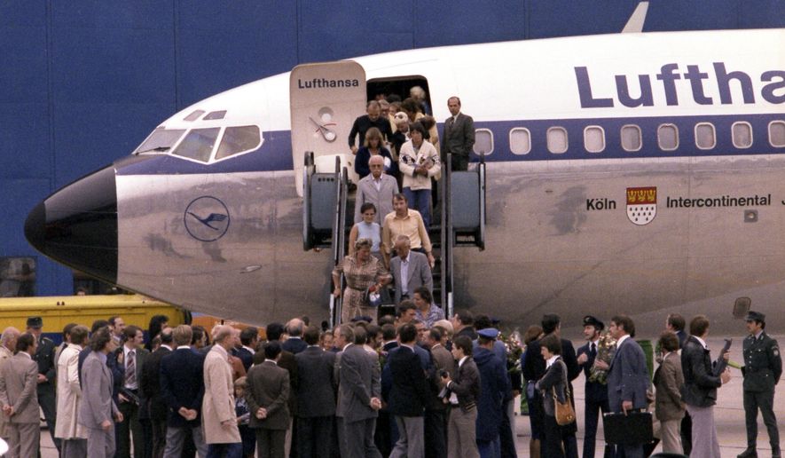 FILE - In this Oct. 18, 1977 file photo the first freed hostages step down the gangway after landing at Frankfurt am Main's airport, in West Germany. Ulrich Wegener, the commander of the German paramilitary unit that ended the hijacking of a plane by Palestinian militants in 1977 has died. (AP Photo/Dieter Endlicher)