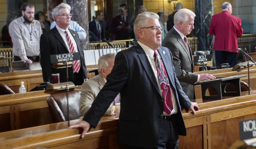 Neb. Speaker of the Legislature Sen. Jim Scheer of Norfolk, stands in the Legislative Chamber on the first day of the 2018 legislative session in Lincoln, Neb., Wednesday, Jan. 3, 2018. Scheer said he's confident lawmakers will have a positive, productive session this year but acknowledged he may be more optimistic than others. Lawmakers begin the 2018 session with a looming state revenue shortfall that could make it harder to pass new spending measures or tax cuts. (AP Photo/Nati Harnik)