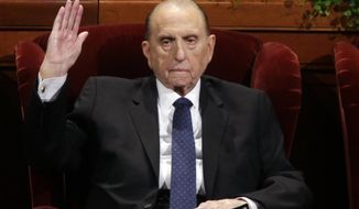FILE - In this April 2, 2016, file photo, President Thomas S. Monson, of The Church of Jesus Christ of Latter-day Saints, raises his hand during a sustaining vote at the two-day Mormon church conference, in Salt Lake City. Monson, the 16th president of the Mormon church, has died after nine years in office. He was 90. (AP Photo/Rick Bowmer, File)