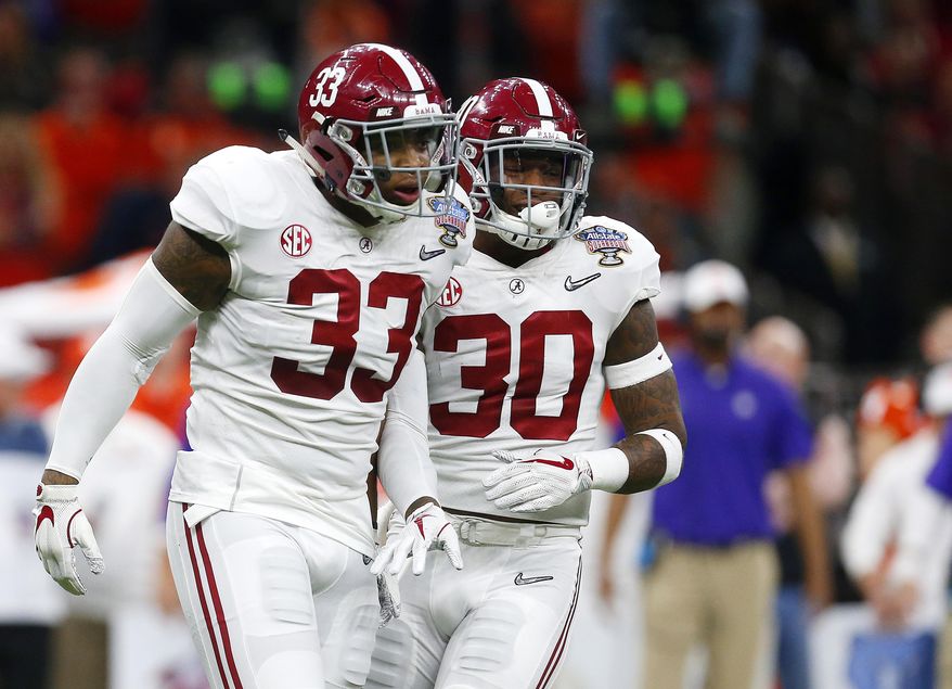 Alabama linebacker Anfernee Jennings (33) and linebacker Mack Wilson (30) celebrate a stop in the first half of the Sugar Bowl semi-final playoff game against Clemson for the NCAA college football national championship, in New Orleans, Monday, Jan. 1, 2018. (AP Photo/Butch Dill)