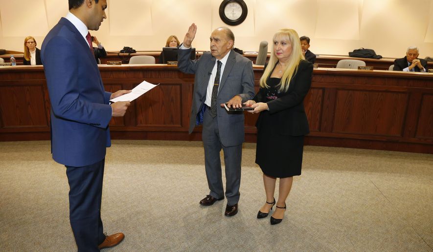 Nintey-three year-old WWII Veteran Vito Perillo, center, is sworn in as mayor of Tinton Falls, N.J., by Senator Vin Gopal, left, during ceremony at Borough Hall, Tinton Falls,NJ. Anna Mae Perillo was at the side of Perillo during ceremony Tuesday, Jan. 2, 2018. (Noah K. Murray /The Asbury Park Press via AP)