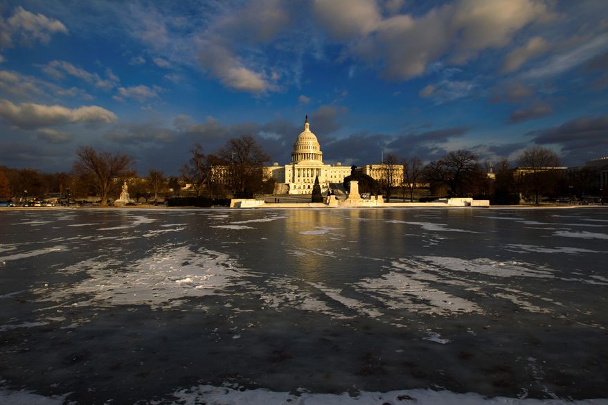 The reflecting pool in front of the U.S. Capitol is frozen at sunset on Thursday. A winter storm unleashed snow, high winds and freezing temperatures on the Eastern Seaboard, moving from Florida to New England. (ASSOCIATED PRESS PHOTOGRAPHS)