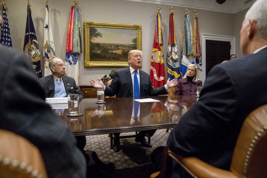 President Donald Trump, accompanied by Sen. Chuck Grassley, R-Iowa, left, Secretary of Homeland Security Kirstjen Nielsen, second from, right, and Vice President Mike Pence, right, speaks at a meeting on immigration with Republican Senators in the Roosevelt Room at the White House, Thursday, Jan. 4, 2018, in Washington. (AP Photo/Andrew Harnik)