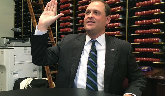 Republican U.S. Rep. Andy Barr swears to the accuracy of his paperwork as he filed for re-election on Thursday, Jan. 4, 2018, in Frankfort, Ky. Barr is seeking a fourth term in Kentucky’s 6th Congressional District. (AP Photo/Adam Beam)