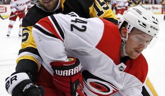 Pittsburgh Penguins&#39; Riley Sheahan (15) goes into the corner after the puck with Carolina Hurricanes&#39; Joakim Nordstrom (42) during the second period of an NHL hockey game in Pittsburgh, Thursday, Jan. 4, 2018. (AP Photo/Gene J. Puskar)