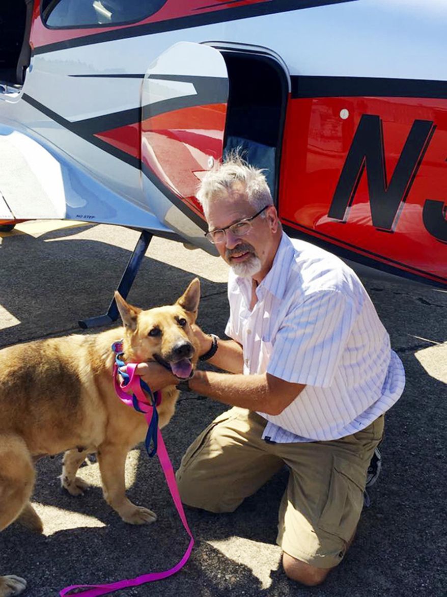 This June 6, 2016, photo provided by Best Fur Friends Rescue, shows Dr. Bill Kinsinger, with Jojo, a dog from Fort Worth Animal Care & Control, at a regional airport in northern Illinois. Officials said Thursday, Jan. 4, 2018, that Kinsinger, a doctor volunteering for a dog rescue operation who failed to land his small plane at an airport in Central Texas as planned and was later tracked by fighter jets flying over the Gulf of Mexico appeared unresponsive and may have been suffering from a lack of oxygen. A Federal Aviation Administration spokesman said the plane kept flying and was last observed on radar 219 miles northwest of Cancun, Mexico, flying at 15,000 feet. Kinsinger took off from Wiley Post Airport in Oklahoma City Wednesday afternoon after filing a flight plan to land in Georgetown, Texas. (Best Fur Friends Rescue via AP)