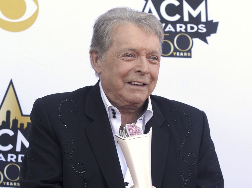 FILE - In this April 19, 2015 file photo, Mickey Gilley poses with the triple crown award on the red carpet at the 50th annual Academy of Country Music Awards at AT&T Stadium in Arlington, Texas. Country music artist Gilley and his son were injured in a car accident in Texas, but both are recovering after minor injuries. A statement from Gilley's publicist on Thursday, Jan. 4, 2018, said the two were injured Wednesday when their car rolled over. (Photo by Jack Plunkett/Invision/AP, File)