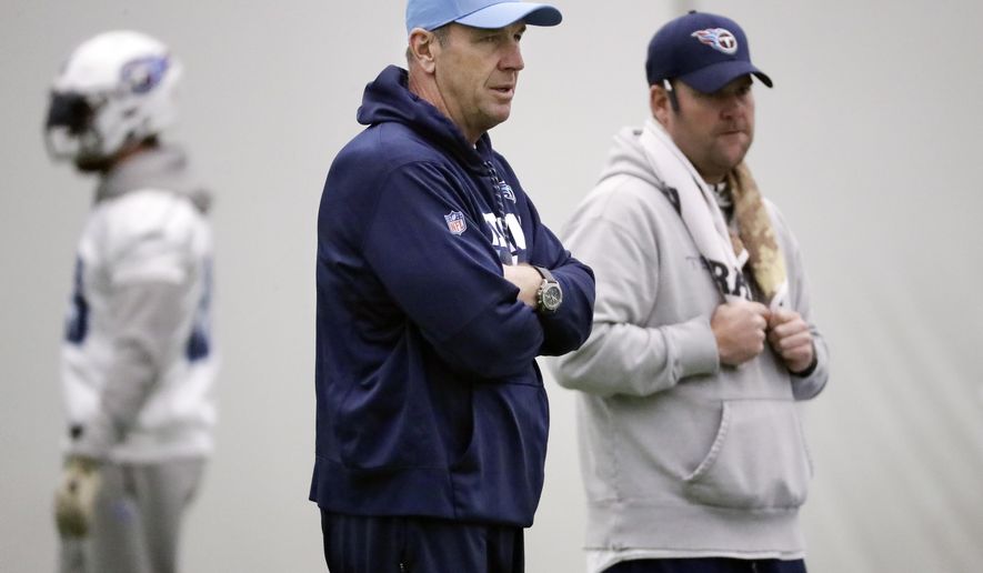 Tennessee Titans head coach Mike Mularkey, center, and general manager Jon Robinson watch during an NFL football practice Thursday, Jan. 4, 2018, in Nashville, Tenn. The Titans are scheduled to play the Kansas City Chiefs Saturday in an AFC wild-card playoff game. (AP Photo/Mark Humphrey)