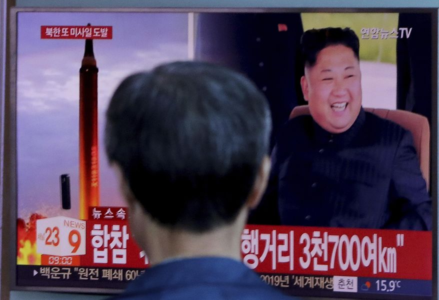 FILE - In this Friday, Sept. 15, 2017, file photo, a man watches a TV screen showing a file footage of North Korea's missile launch and North Korean leader Kim Jong Un, at the Seoul Railway Station in Seoul, South Korea. With little time to spare, North and South Korea are preparing to discuss Kim Jong Un’s offer to send a delegation to next month’s Winter Olympics. The signs read "South Korea's Joint Chiefs of Staff said the missile traveled about 3,700 kilometers." (AP Photo/Ahn Young-joon, File)
