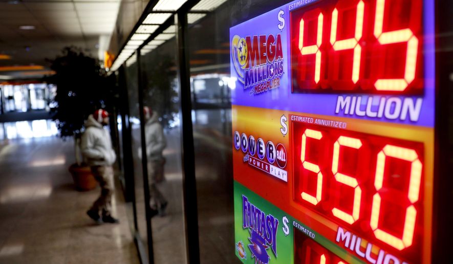 A sign advertises Powerball and Mega Millions lottery jackpots at a store in Atlanta, Thursday, Jan. 4, 2018. An estimated $550 million jackpot is up for grabs on Saturday night's Powerball lottery drawing, making it potentially the 8th largest prize in the nation. (AP Photo/David Goldman)