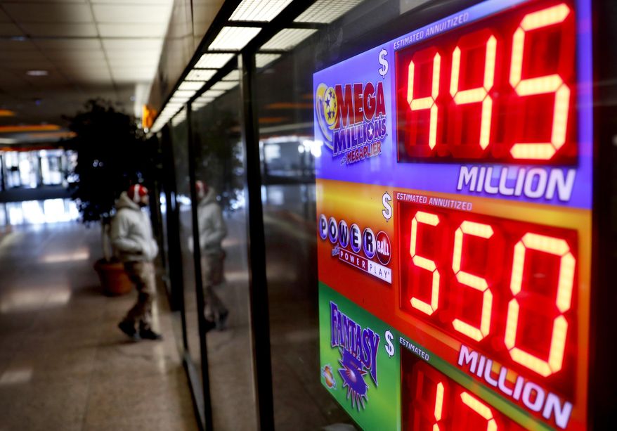 A sign advertises Powerball and Mega Millions lottery jackpots at a store in Atlanta, Thursday, Jan. 4, 2018. An estimated $550 million jackpot is up for grabs on Saturday night's Powerball lottery drawing, making it potentially the 8th largest prize in the nation. (AP Photo/David Goldman)