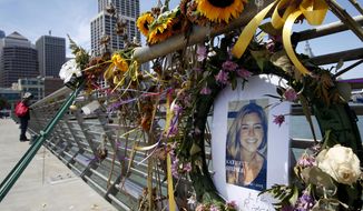 In this July 17, 2015, file photo, flowers and a portrait of Kate Steinle remain at a memorial site on Pier 14 in San Francisco. (Paul Chinn/San Francisco Chronicle via AP, File)
