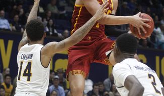 Southern California&#39;s Jordan Usher, center, shoots over California&#39;s Don Coleman, left, and Juhwan Harris-Dyson, during the first half of an NCAA college basketball game, Thursday, Jan. 4, 2018, in Berkeley, Calif. (AP Photo/George Nikitin)