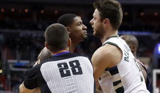 Washington Wizards guard Bradley Beal, center, and Milwaukee Bucks guard Matthew Dellavedova, right, are separated by referee Kevin Scott during the second half of an NBA basketball game Saturday, Jan. 6, 2018, in Washington. Dellavedova was ejected after the play. The Bucks won 110-103. (AP Photo/Alex Brandon)