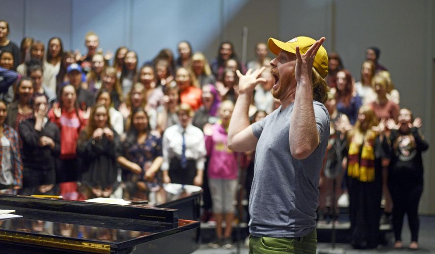 In this Friday, Dec. 15, 2017 photo, Simon Nissen leads a section of his choir class in vocal warm-ups in preparation for the holiday concert at Kenai Central High School in Kenai, Alaska. Since the start of the school year, the Kenai Central High School choir has been singing. From the chambers during Borough Assembly meeting, to Soldotna Creek Park, to their own holiday concert on Dec. 17, the choir's songs have been heard throughout the community. (Kat Sorensen/Peninsula Clarion via AP)