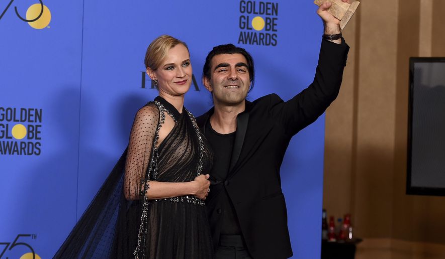 Diane Kruger, left, and Fatih Akin poses in the press room with the award for best motion picture - foreign language for "In The Fade" at the 75th annual Golden Globe Awards at the Beverly Hilton Hotel on Sunday, Jan. 7, 2018, in Beverly Hills, Calif. (Photo by Jordan Strauss/Invision/AP)