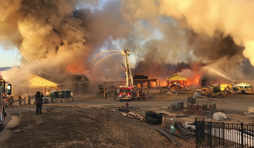 Firefighters work to put out a blaze at a construction site for a new nursing home Sunday, Jan. 7, 2018, in Fishersville, Va. Firefighters fought the blaze in temperatures that were in the single digits. (Roger Watson/The Daily News Leader via AP)