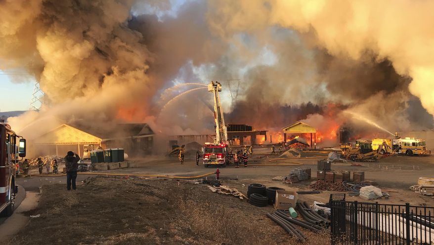 Firefighters work to put out a blaze at a construction site for a new nursing home Sunday, Jan. 7, 2018, in Fishersville, Va. Firefighters fought the blaze in temperatures that were in the single digits. (Roger Watson/The Daily News Leader via AP)