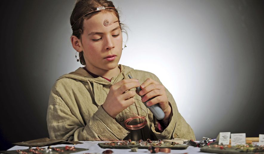 In this Dec. 28, 2017 photo, Simon Gomez, 12, demonstrates his jewelry-making technique in Mount Vernon, Wash. Gomez's work is being sold at the Skagit Valley Food Coop. He has been making jewelry since he was 6-years old. (Charles Biles/Skagit Valley Herald via AP)