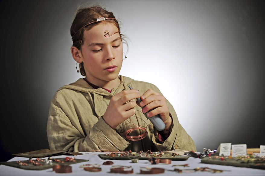 In this Dec. 28, 2017 photo, Simon Gomez, 12, demonstrates his jewelry-making technique in Mount Vernon, Wash. Gomez's work is being sold at the Skagit Valley Food Coop. He has been making jewelry since he was 6-years old. (Charles Biles/Skagit Valley Herald via AP)