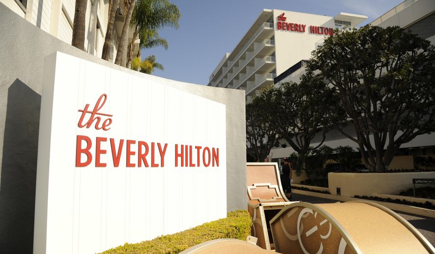 FILE - In this Jan. 8, 2015 file photo, The Beverly Hilton is pictured during the 72nd Annual Golden Globe Awards Preview Day at the Beverly Hilton in Beverly Hills, Calif. The 75th Golden Globe Awards will be handed out on Sunday, Jan. 7, 2018, at a ceremony that is being held under the cloud of the sexual misconduct scandal that started with several high-profile actresses accusing Harvey Weinstein of sexual harassment or abuse. Many actresses say they are planning to wear black Sunday to show solidarity with victims of harassment and abuse. (Photo by Chris Pizzello/Invision/AP, File)