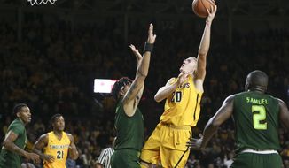 Wichita State center Rauno Nurger shoots over South Florida forward Isaiah Manderson during the first half of an NCAA college basketball game on Sunday, Jan. 7, 2018, in Wichita, Kan. (Travis Heying/The Wichita Eagle via AP)