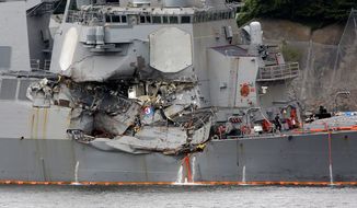 Damaged part of USS Fitzgerald is seen at the U.S. Naval base in Yokosuka, southwest of Tokyo Sunday, June 18, 2017.  Navy divers found a number of sailors&#39; bodies Sunday aboard the stricken USS Fitzgerald that collided with a container ship in the busy sea off Japan, but a spokeswoman said not all seven missing had been accounted for. (AP Photo/Eugene Hoshiko)
