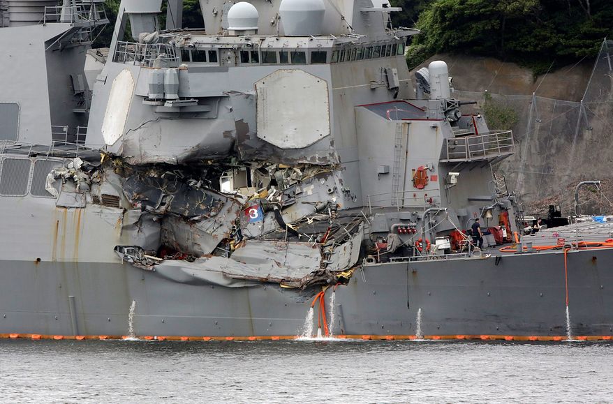 Damaged part of USS Fitzgerald is seen at the U.S. Naval base in Yokosuka, southwest of Tokyo Sunday, June 18, 2017.  Navy divers found a number of sailors&#39; bodies Sunday aboard the stricken USS Fitzgerald that collided with a container ship in the busy sea off Japan, but a spokeswoman said not all seven missing had been accounted for. (AP Photo/Eugene Hoshiko)