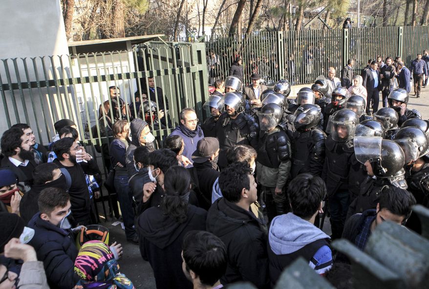 In this Dec. 30, 2017, file photo taken by an individual not employed by The Associated Press and obtained by the AP outside Iran, anti-riot Iranian police prevent university students to join other protesters over Iran's weak economy, in Tehran, Iran. New unrest in Iran over the past 10 days appears to be waning, but anger over the economy persists. (AP Photo, File)