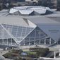 FILE - This Nov. 1, 2017, file photo shows the Mercedes-Benz stadium in Atlanta. Atlanta’s new $1.5 billion stadium is about to be on perhaps its largest national stage for the Monday, Jan. 8, 2018, College Football Playoff title game, fans say the glitzy facility is living up to the hype despite a series of construction setbacks that delayed its opening. (AP Photo/Mike Stewart, File)