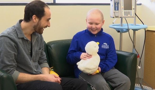 In this undated photo made from video, 12-year-old cancer patient Ethan Daniels at a medical facility in Atlanta speaks with Aaron Horowitz, co-founder and CEO of Sproutel, who designed &amp;quot;My Special Aflac Duck&amp;quot; to promote emotional well-being by helping children living with cancer develop a sense of control and manage stress through interactive technology. (AP Photo/Marina Hutchinson) ** FILE **