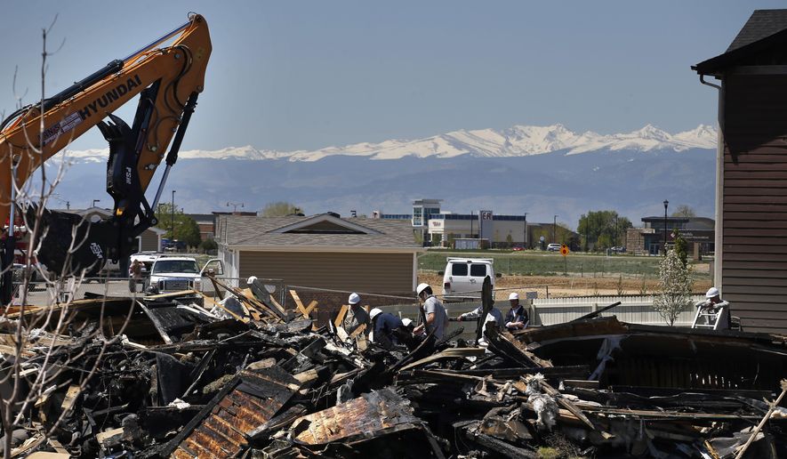 FILE - In this May 4, 2017, file photo, workers dismantle the charred remains of a house where an explosion killed two people in Firestone, Colo. Energy companies, local governments and advocacy groups will debate proposed new rules for oil and gas pipelines in Colorado after the fatal explosion last year blamed on leaking gas. The Colorado Oil and Gas Conservation Commission opens two days of hearings Monday, Jan. 8, 2018, on regulations for installing, testing and shutting down lines that carry oil and gas from wells to equipment. (AP Photo/Brennan Linsley, File)