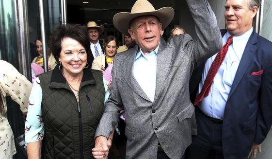 Cliven Bundy walks out of federal court with his wife Carol on Monday, Jan. 8, 2018, in Las Vegas, after a judge dismissed criminal charges against him and his sons accused of leading an armed uprising against federal authorities in 2014. (K.M. Cannon/Las Vegas Review-Journal via AP)