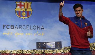 Brazilian soccer player Philippe Coutinho Correia poses for the media at the Camp Nou stadium in Barcelona, Spain, Sunday, Jan. 7, 2018. Philippe Coutinho is joining Barcelona after Liverpool agreed Saturday to sell the Brazilian in a deal that makes him one of the most expensive players in soccer history. (AP Photo/Manu Fernandez)