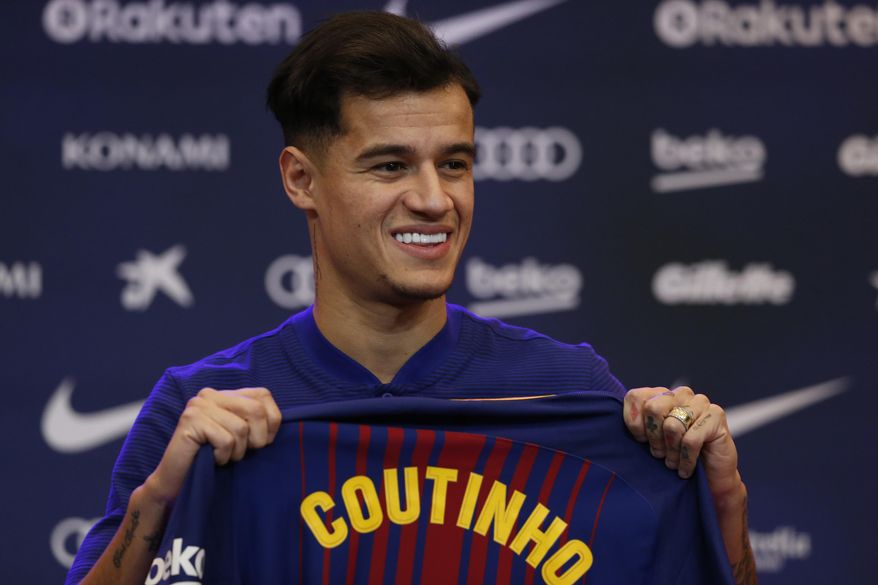Barcelona&#39;s new signing Brazilian Philippe Coutinho poses for the media, during his official presentation at the Camp Nou stadium in Barcelona, Spain, Monday, Jan. 8, 2018. Coutinho is joining Barcelona after Liverpool agreed Saturday to sell the Brazilian in a deal that makes him one of the most expensive players in soccer history. (AP Photo/Manu Fernandez)