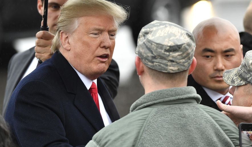 President Donald Trump is greeted by military personnel as he arrives at Nashville International Airport in Nashville, Tenn., Monday, Jan. 8, 2018, to speak at the American Farm Bureau Federation's Annual Convention. (Larry McCormack/The Tennessean via AP)