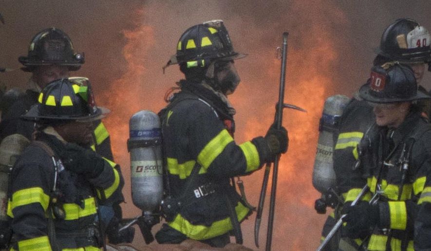 Firefighters battle a fire in an upper Manhattan residential building blaze Monday, Jan. 8, 2018, in New York. Several people were injured in the fire, but FDNY says all injuries were non-life threatening. (Katherine Gerberich via AP)