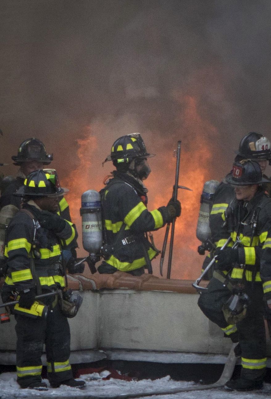 Firefighters battle a fire in an upper Manhattan residential building blaze Monday, Jan. 8, 2018, in New York. Several people were injured in the fire, but FDNY says all injuries were non-life threatening. (Katherine Gerberich via AP)