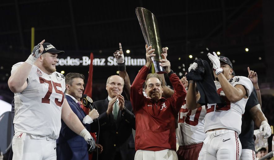 Alabama head coach Nick Saban holds up the championship trophy after overtime of the NCAA college football playoff championship game against Georgia, Monday, Jan. 8, 2018, in Atlanta. Alabama won 26-23. (AP Photo/David J. Phillip)