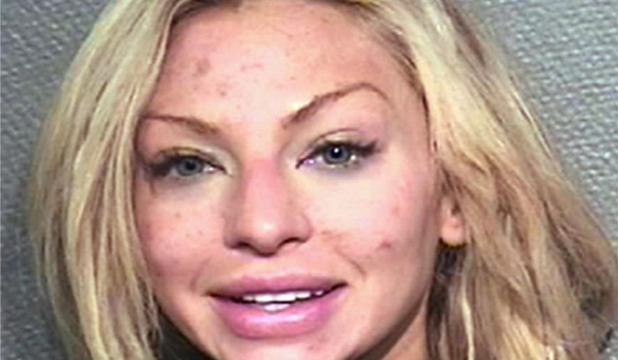 This photo provided by the Houston Police Department shows Lindy Lou Layman who was arrested Saturday, Jan. 6, 2018, on criminal mischief charges after her date with Anthony Buzbee, a prominent Houston trial lawyer. Authorities say Layman, of Dallas, was intoxicated while on a first date with Buzbee and caused at least $300,000 in damage to his art collection, including two Andy Warhol paintings. (Houston Police Department via AP)