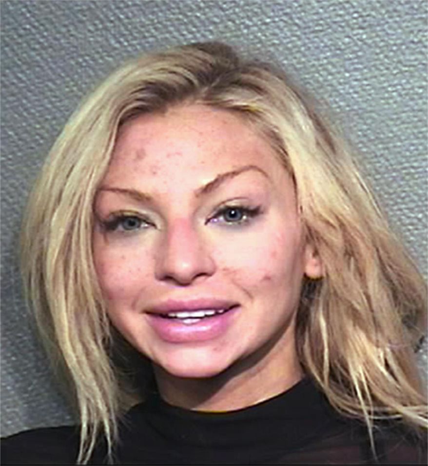 This photo provided by the Houston Police Department shows Lindy Lou Layman who was arrested Saturday, Jan. 6, 2018, on criminal mischief charges after her date with Anthony Buzbee, a prominent Houston trial lawyer. Authorities say Layman, of Dallas, was intoxicated while on a first date with Buzbee and caused at least $300,000 in damage to his art collection, including two Andy Warhol paintings. (Houston Police Department via AP)